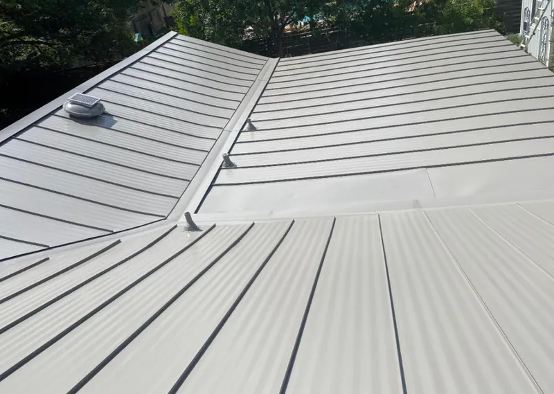 Solar attic fan installed on a metal roof for Roof Ventilation in Shaker Heights